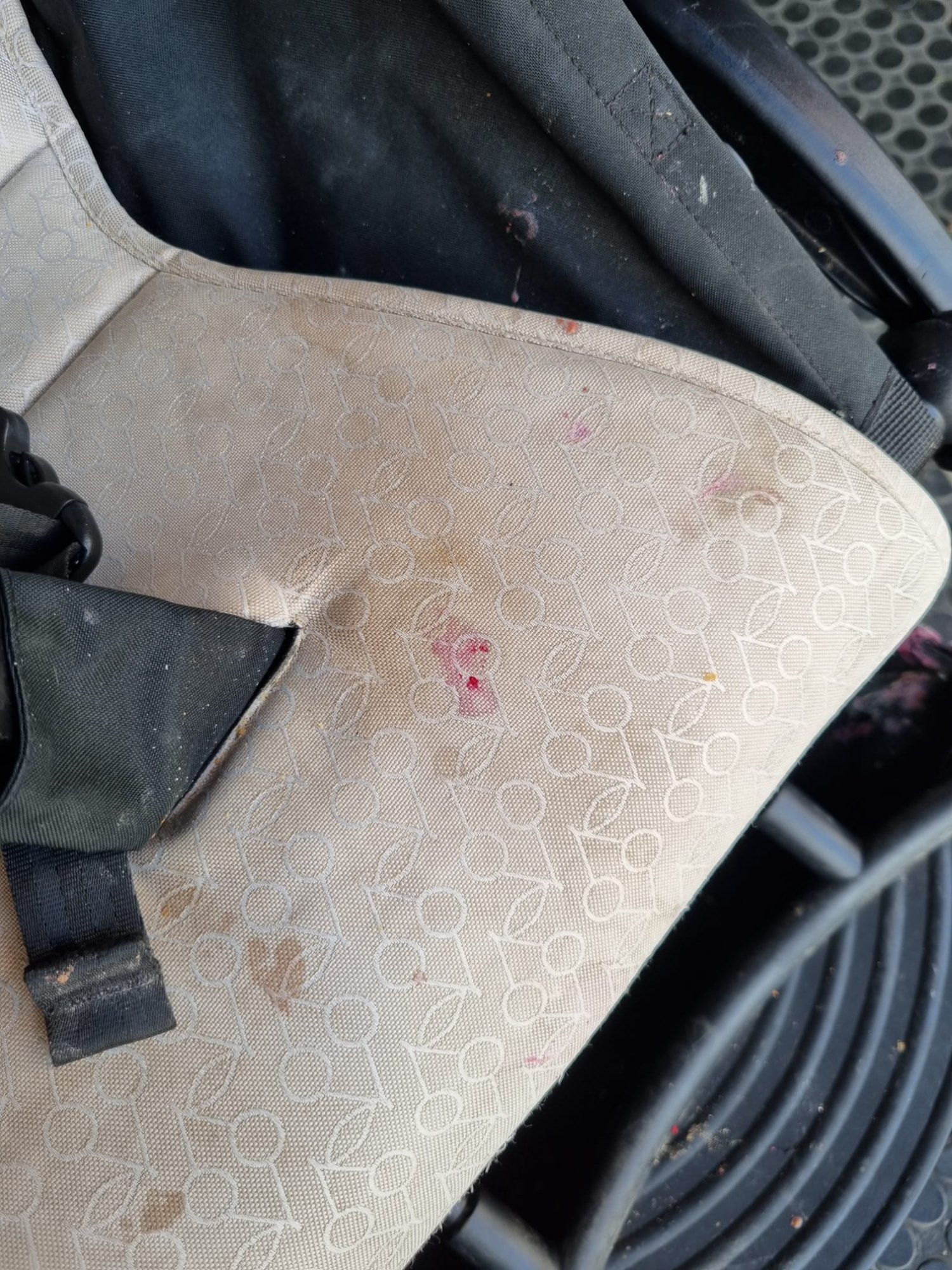 Dirty pram seat with food stains and marks before cleaning